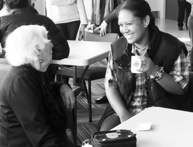 Young person and older person connecting over a cuppa